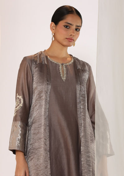 Embroidered silk kurta paired with tissue assymetric cape