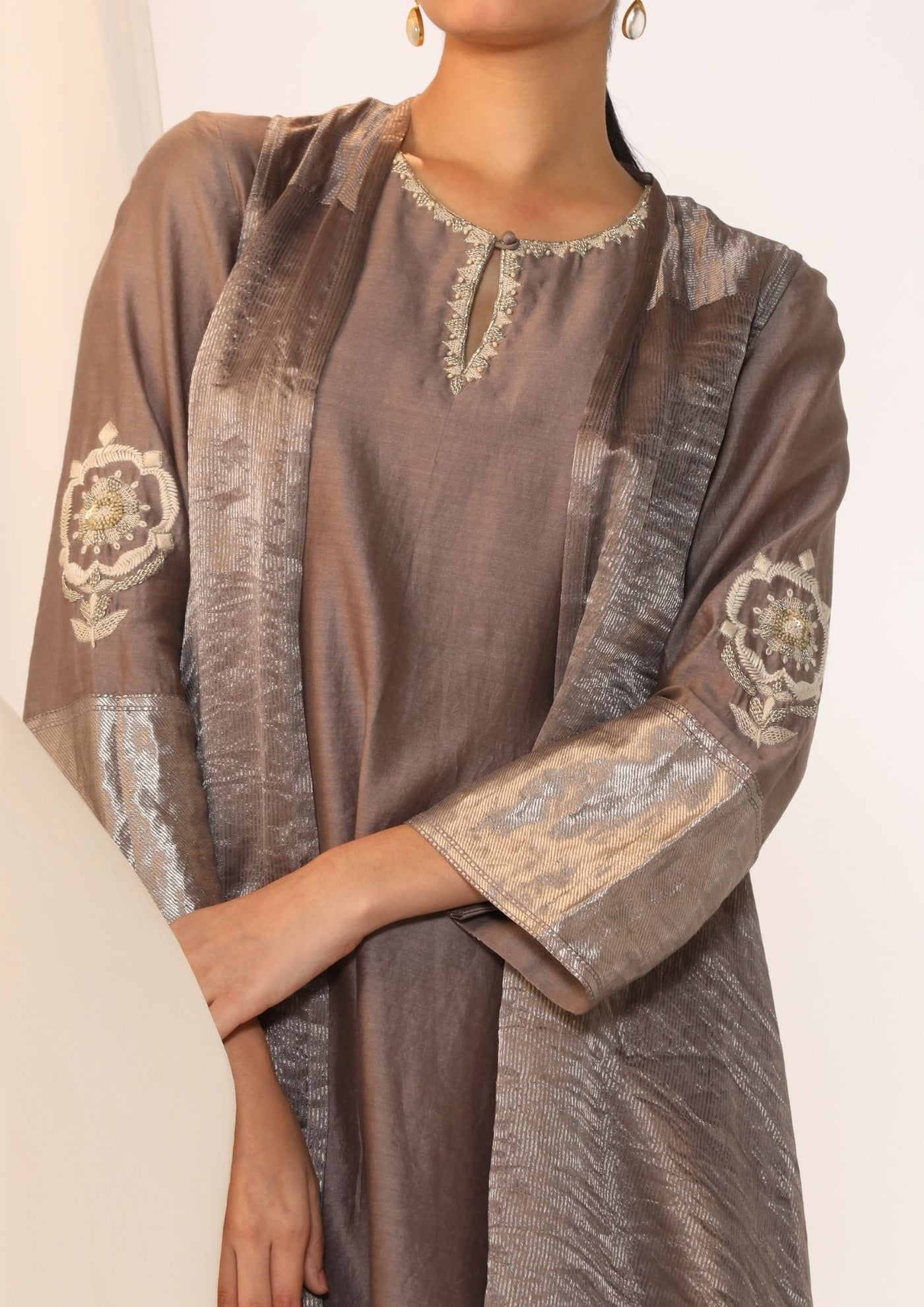 Embroidered silk kurta paired with tissue assymetric cape