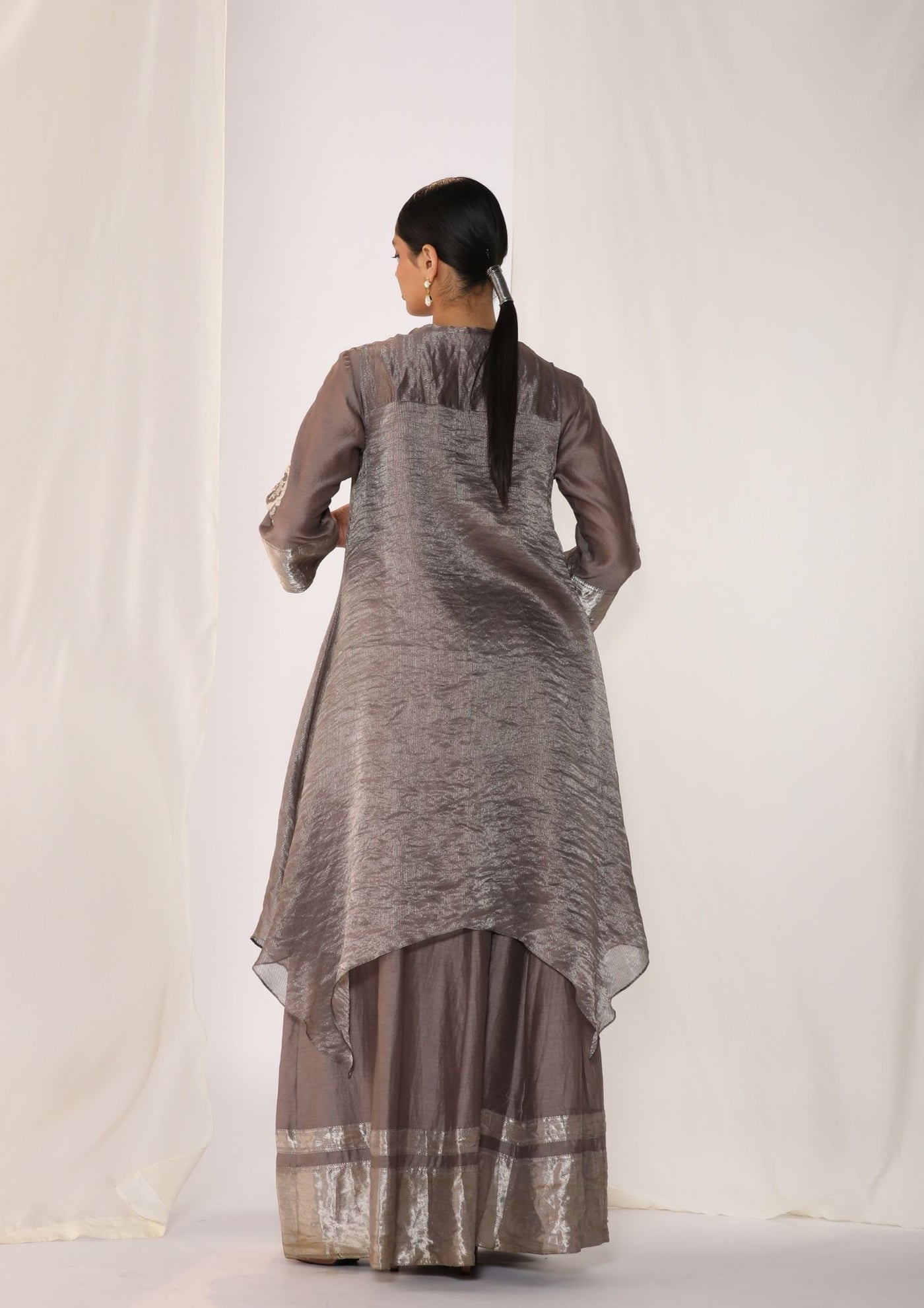 Embroidered silk kurta paired with tissue assymetric cape