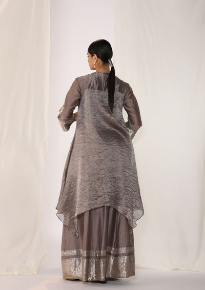 Embroidered silk kurta paired with tissue assymetric cape