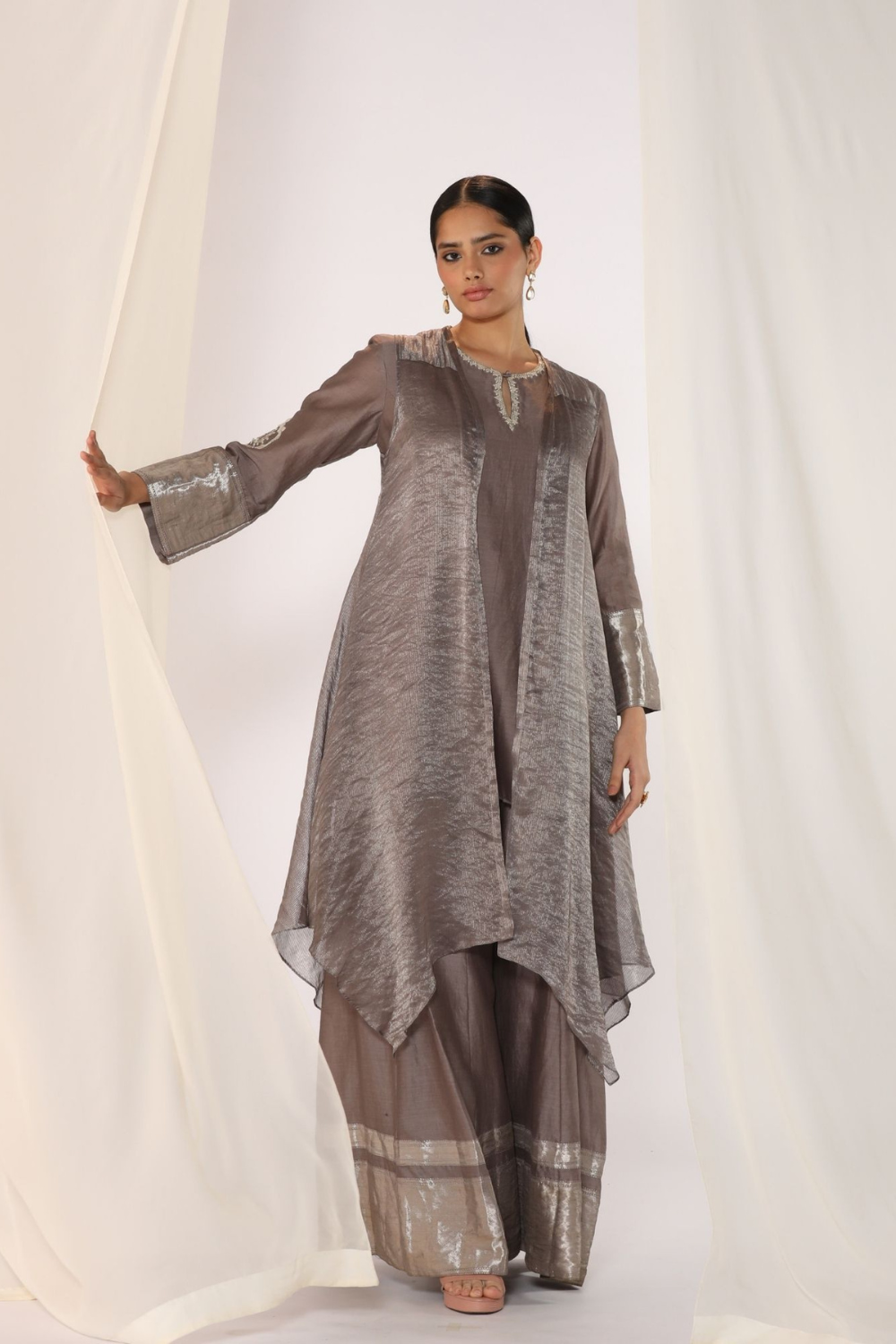 Embroidered silk kurta paired with tissue assymetric cape